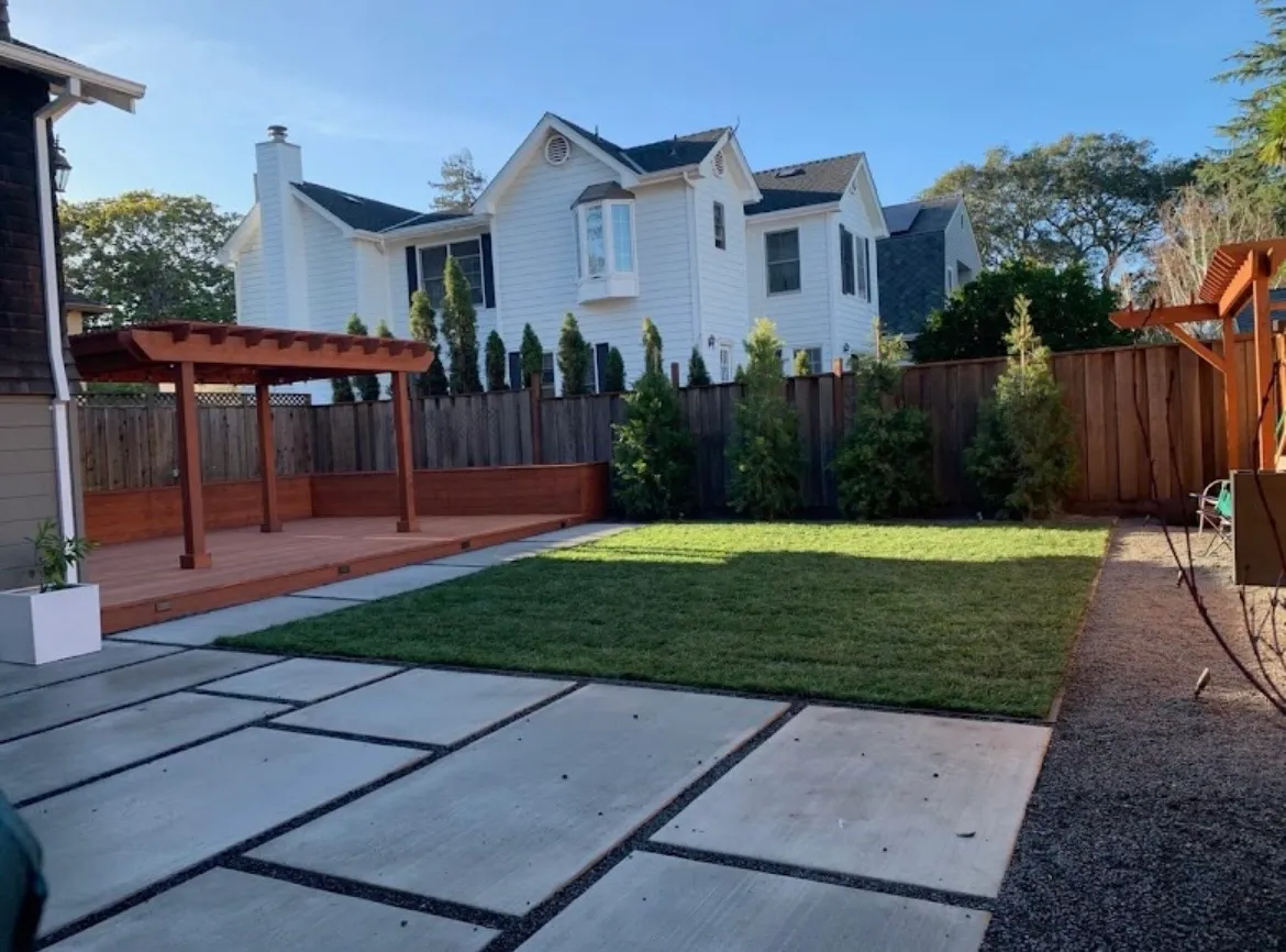 Backyard with new sod lawn, large concrete pavers and a redwood pergola