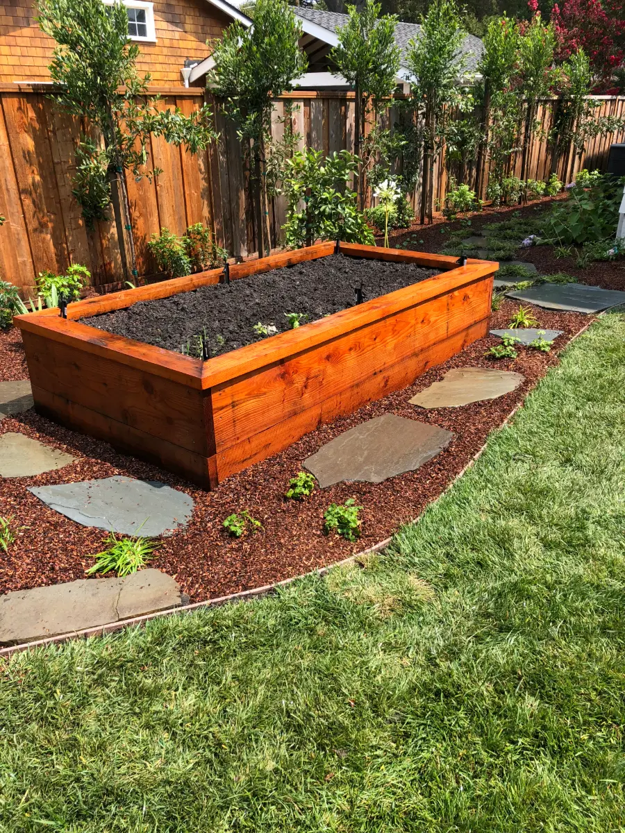 Redwood raised planter box with flagstone path, fresh mulch and new lawn
